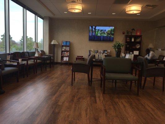 Waiting area is spacious with plenty of seating and a tv