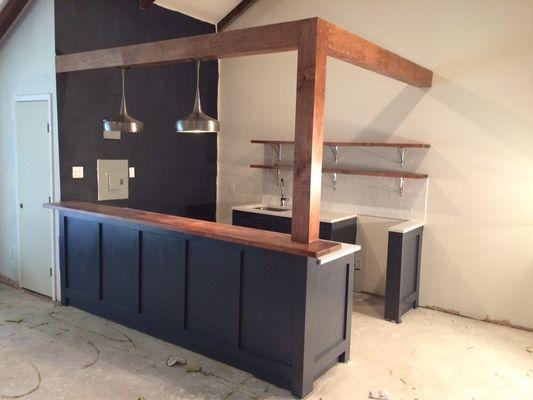 Custom built kitchenette. With maple surround, bar and shelves.