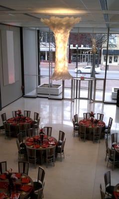 A beautiful chandelier hangs overhead, framed by 10 5' square skylights!