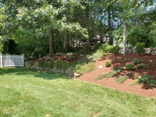 Flocks that over flow this beautiful flower bed stone wall in the spring!