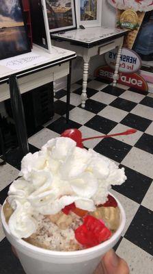 Small oatmeal cookie crumble with gummy bears, whipped cream, and cherry.