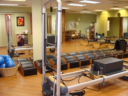 We have a variety of equipment ot help you reach your goals!  Seen her is our Pilates reformer machine.