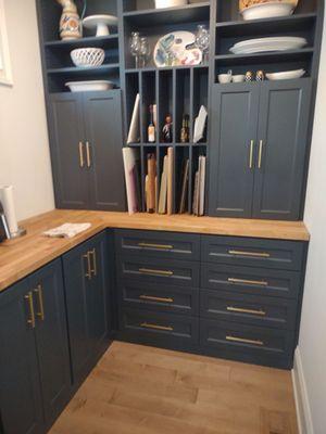 Pantry with several drawers, shelves, and counter top space for easy storage.