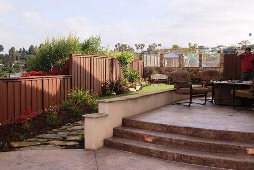 Stamped concrete stairs, raised patio with stucco finish and  stone cap seat wall