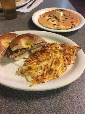 Breakfast bagel, hash browns, and a chocolate chip pancake.