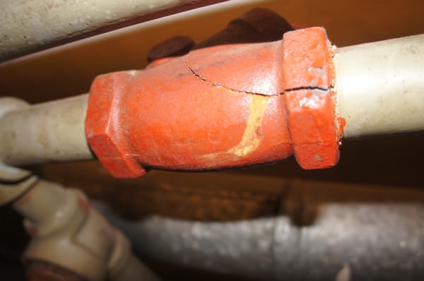 This pipe has been frozen and cracked.  The residence had been improperly winterized it was found during the inspections saving thousands.