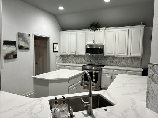 Opened up the kitchen . Check out the back splash and the quartz countertop