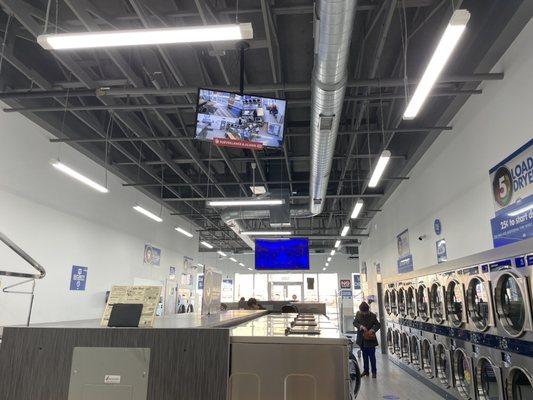 Large laundromat with security cameras.