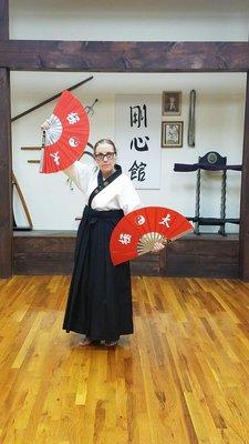 Sensei Lehmuth (senior) posing with her weapons (traditional fans)