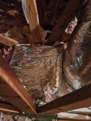 The workers concealed unsealed corner joints on the homemade plenum boxes by laying other type of insulation over the area.