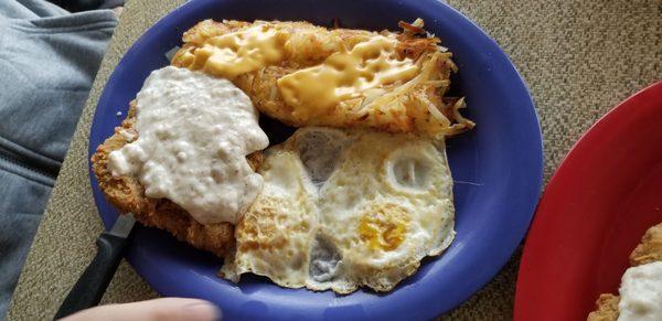 Country fried steak with gravy and 2 eggs over medium,  hash browns with onions and cheese. Toast not in the pic.