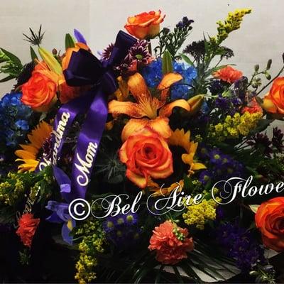 Bel Aire family casket Spray.  All casket adornments can be customized in all design styles, colors and flowers.