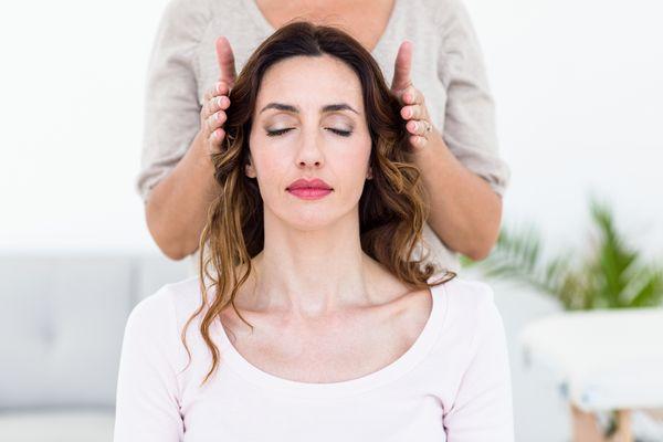 Woman getting reiki healing