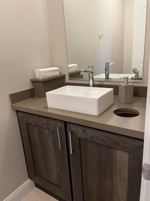 Small powder room with towel pedestal and discard hole