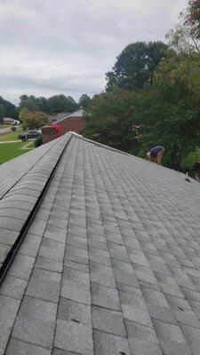 The picture shows how W.C. HomeServices takes pride in the correct way at keeping the Shingles and Ridge vent of the home straight.