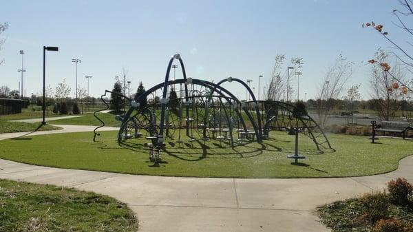 Playground near Splash Pad - features artificial grass under the gym set... No worries about mud.