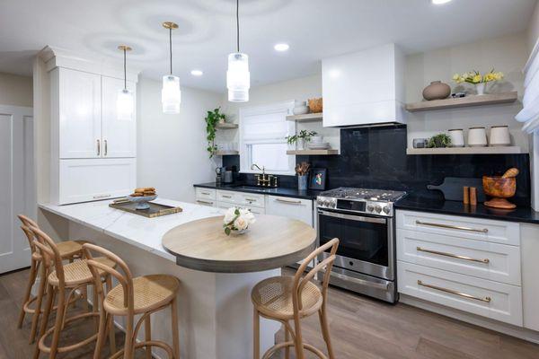 Harmony in design: A cozy eat-in kitchen that marries classic comfort with modern black accents.