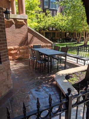 Side view of patio, not pictured are two other large garden beds with various shrubs and ground cover