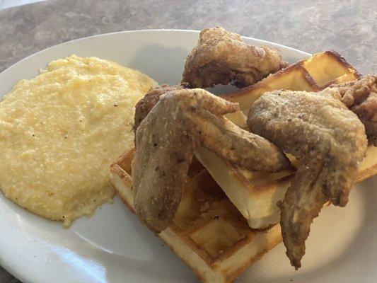 Golden crispy wings served on two golden Belgian waffles and complemented with buttery grits.