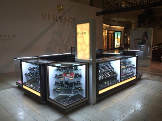 We are located at the top of the Nordstrom wing of the mall, directly in front of Versace.