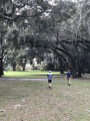 Walking down fairway number 2. You can see the basket just to the left of the bigger of the trees in the distance. Yellow top.