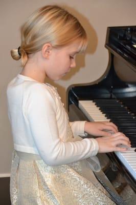 Piano student performing at our recital.  Piano lessons from ages 5 and up!