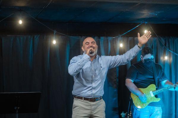 Men's Pastor Eliab Perales leads a song during praise & worship.