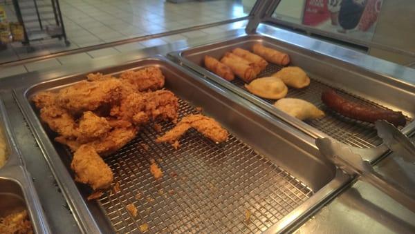 Fried chicken, meat pies egg rolls and fried hot sausage