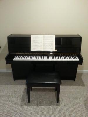 Piano lessons are taught on a Kawai upright piano.