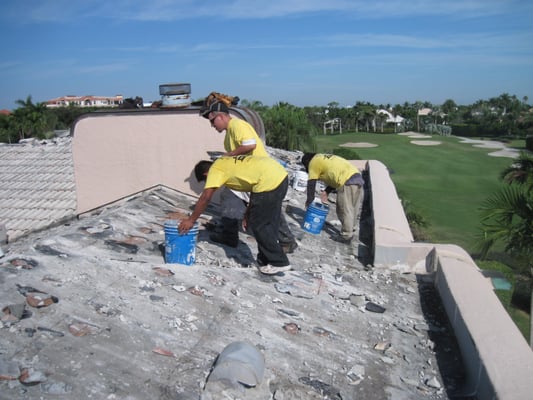 Carefully tearing off the tile roof