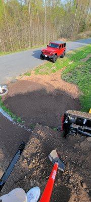 Notice the difference in real topsoil then red clay fill dirt.  It had rocks, cable, clogs, etc.