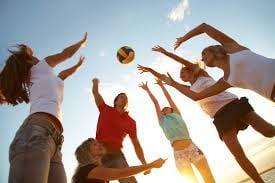 After a day of learning,students take a brake and enjoy a game of volleyball on the beach.  In Florida its always a beach day.