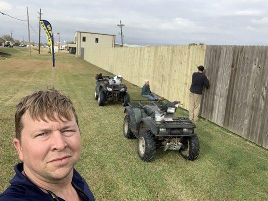 The owners repairing the fence damaged in hurricane.