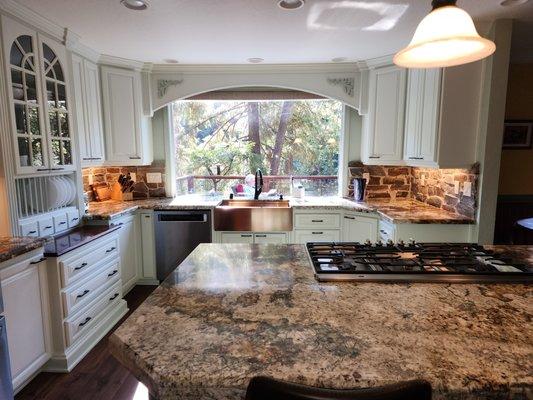 Granite counter with rock backsplash.