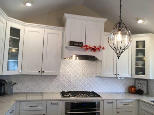 Tundra painted cabinets with decorative backsplash.