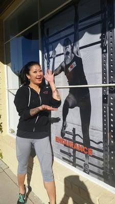 Here is Candie, a personal trainer, at Mission Fitness Center, next to her giant size image!