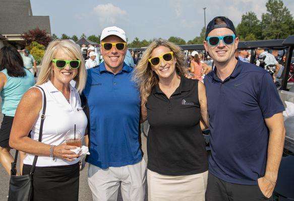 A group of golfers wearing Metamora State Bank Sunglasses