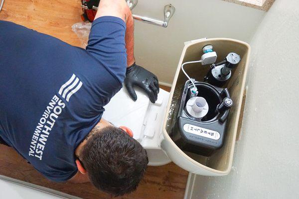 Southwest Environmental Technician installing a new Naigara Stealth toilet.