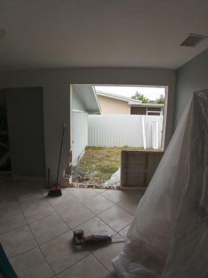 Removed a window to install a impact door. Cinder blocks had to be removed and replaced as needed.