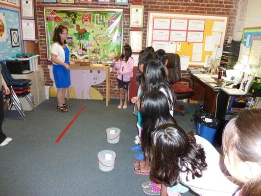 Mrs. Wright showing the 4th graders a learning activity for summer 2014.