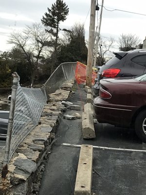 Damaged fencing that keeps people from falling to their death or being seriously injured to the parking below