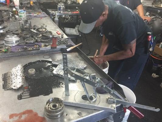 Aamco Master Rebuilder cleaning internal parts inside a transmission