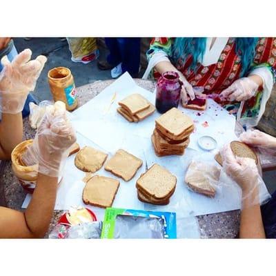 Preparing pb and j sandwiches to directly give out onskid row.