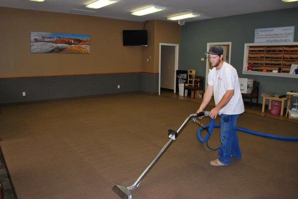 Carpet cleaning technician cleaning carpets.