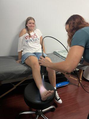 Daughter getting localized treatment for her ankle