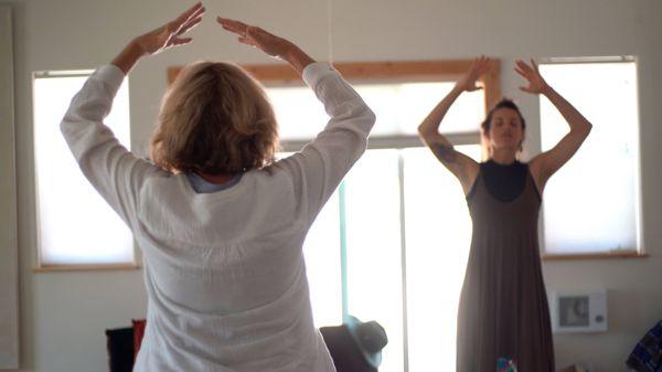 Teaching Qigong to a class.