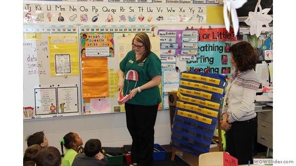 Our hygienist, Audra, teaching children about the importance of oral hygiene.