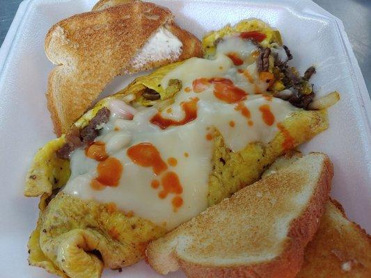 Philly cheese steak omlete with provolone cheese and hotsauce. Customize your own deluxe omlete!