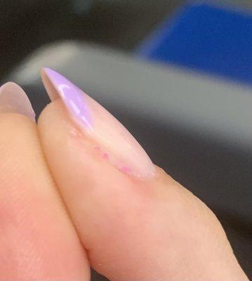 Poorly filed and old regular nail polish still visible