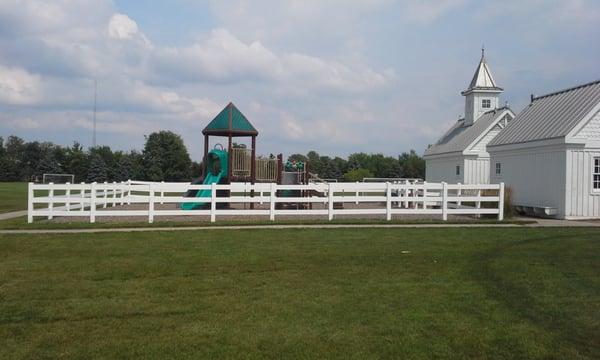 Playground by soccer fields. No shade.